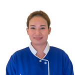 Portrait of a smiling person wearing a blue uniform with white collar, featuring the 'Excellence Center' logo on the chest area.