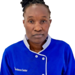 Portrait of a woman in a blue chef jacket with white trim, facing the camera against a white background at the Excellence Center (informational)