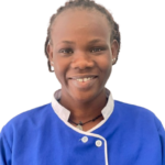 Smiling person wearing a blue uniform with white trim and 'Excellence Center' embroidered on the chest.