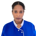 Portrait of a woman in a royal blue uniform with white piping and the 'Excellence Center' logo, looking straight at the camera.