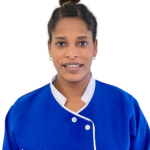 Portrait of a woman in a blue uniform with white trim, facing the camera. The uniform shows 'Excellence Center' on the chest.