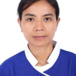 Professional head-and-shoulders photo of a woman in a blue uniform with white collar, neutral expression.