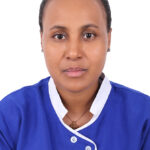 Portrait of a woman in a blue uniform with white trim, facing the camera.