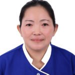 Portrait of an Asian woman in a blue medical uniform, facing the camera with a neutral expression.