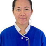 Portrait of a smiling woman in a blue uniform with white trim, against a white background (Excellence Center logo visible).