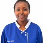 Smiling woman in a blue uniform with white trim, facing the camera against a white background.