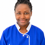 Portrait of a smiling staff member in a blue uniform with white trim, against a white background (Excellence Center logo visible).