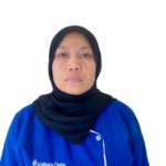 Woman in a blue uniform with an Excellence Center logo, wearing a black hijab, facing the camera against a white background.