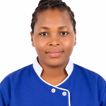 Portrait of a woman in a blue scrub top with white trim, facing the camera with a neutral expression.