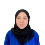 Portrait of a woman in a black hijab and blue uniform facing the camera, with 'Attendance Center' text on the chest.