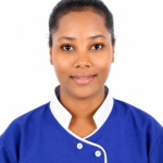 Portrait of a female healthcare worker in a blue uniform facing the camera.
