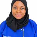 Portrait of a woman in a black hijab and blue uniform with 'Excellence Center' logo on a white background.