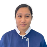 Portrait of a woman wearing a blue chef-style uniform with white trim, facing the camera with a neutral expression; logo reads 'Excellence Center' on the left chest.