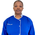 Portrait of a woman in a blue uniform with white trim, facing the camera; small white text appears on the left chest.