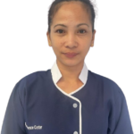 Portrait of a woman in a navy blue uniform with white trim, looking at the camera; ‘Science Center’ text is visible on the chest.