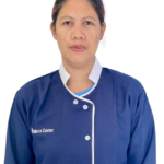 Portrait of a woman in a blue nurse's uniform facing forward.