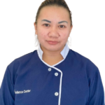 Portrait of a woman in a blue uniform with white trim, looking at the camera.