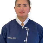 Portrait of a woman in a navy uniform with white piping and the 'Excellence Center' logo, facing the camera with a neutral expression.