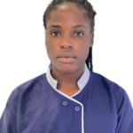 Portrait of a young woman in a blue chef jacket with 'Excellence Center' embroidery, looking straight at the camera against a white background.