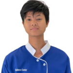 Front-facing portrait of a young person in a blue uniform with a white collar, standing against a plain background. The uniform has 'Excellence Center' embroidered on the chest.