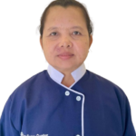 Portrait of a woman in a blue uniform with white trim, standing against a white background; 'Excellence Center' logo on the chest.