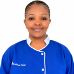Portrait of a smiling woman in a blue uniform with white trim, against a white background; 'Excellence Center' logo visible on her chest.