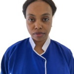 Portrait of a woman with dark hair in a blue scrub uniform with white trim, facing the camera; 'Excellence Center' embroidered on the chest.