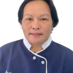 Portrait of a staff member wearing a navy uniform with white trim, featuring an 'Excellence Center' logo on the chest.