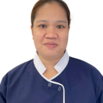 Portrait of a woman wearing a navy blue uniform with white trim and the 'Excellence Center' logo on the chest, against a white background.