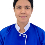 Portrait of a woman in a blue uniform with white trim, smiling at the camera; 'Excellence Center' logo visible on the chest.